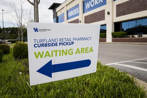 A sign denotes pharmacy curbside pickup area.