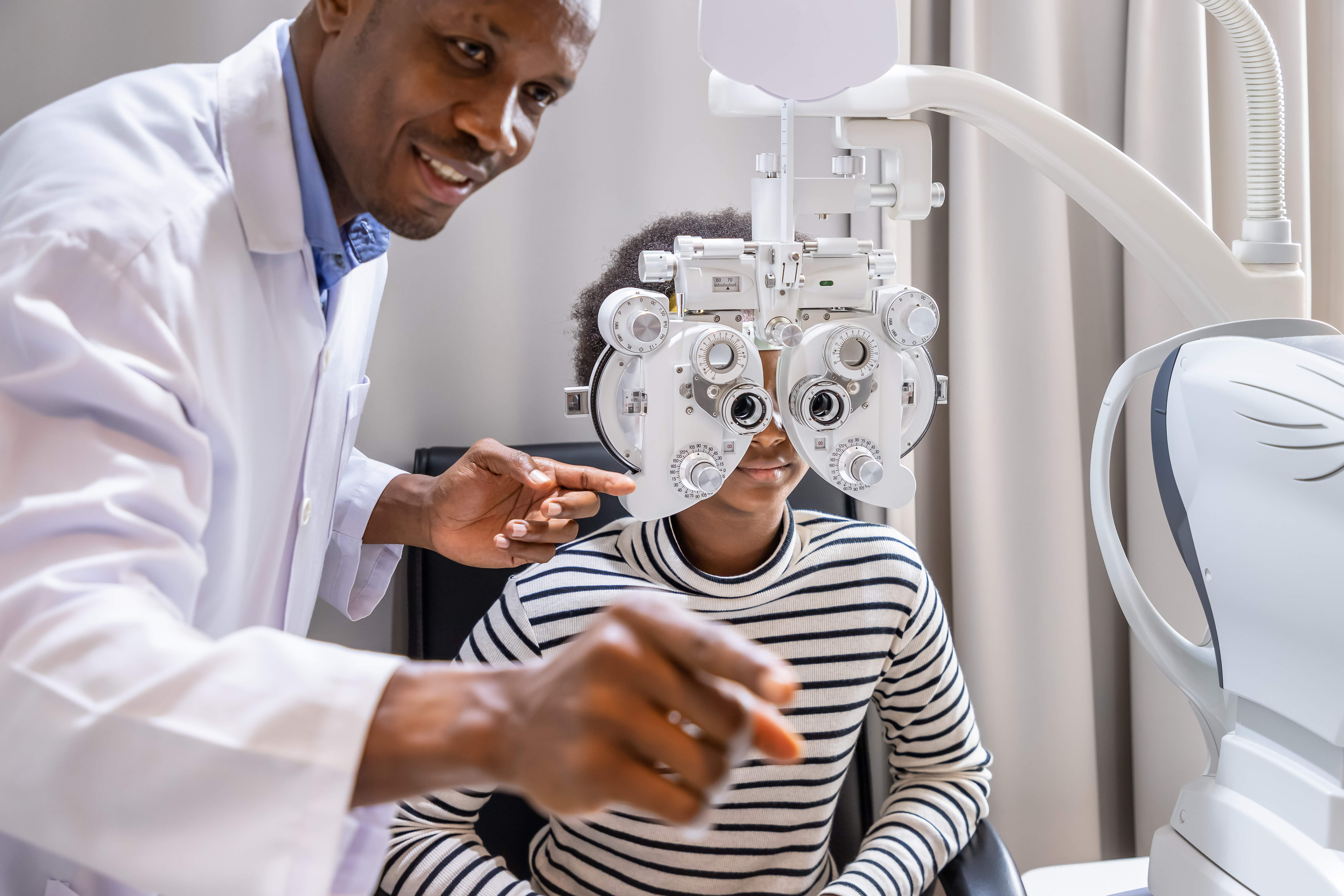 Eye doctor providing services to a young girl.