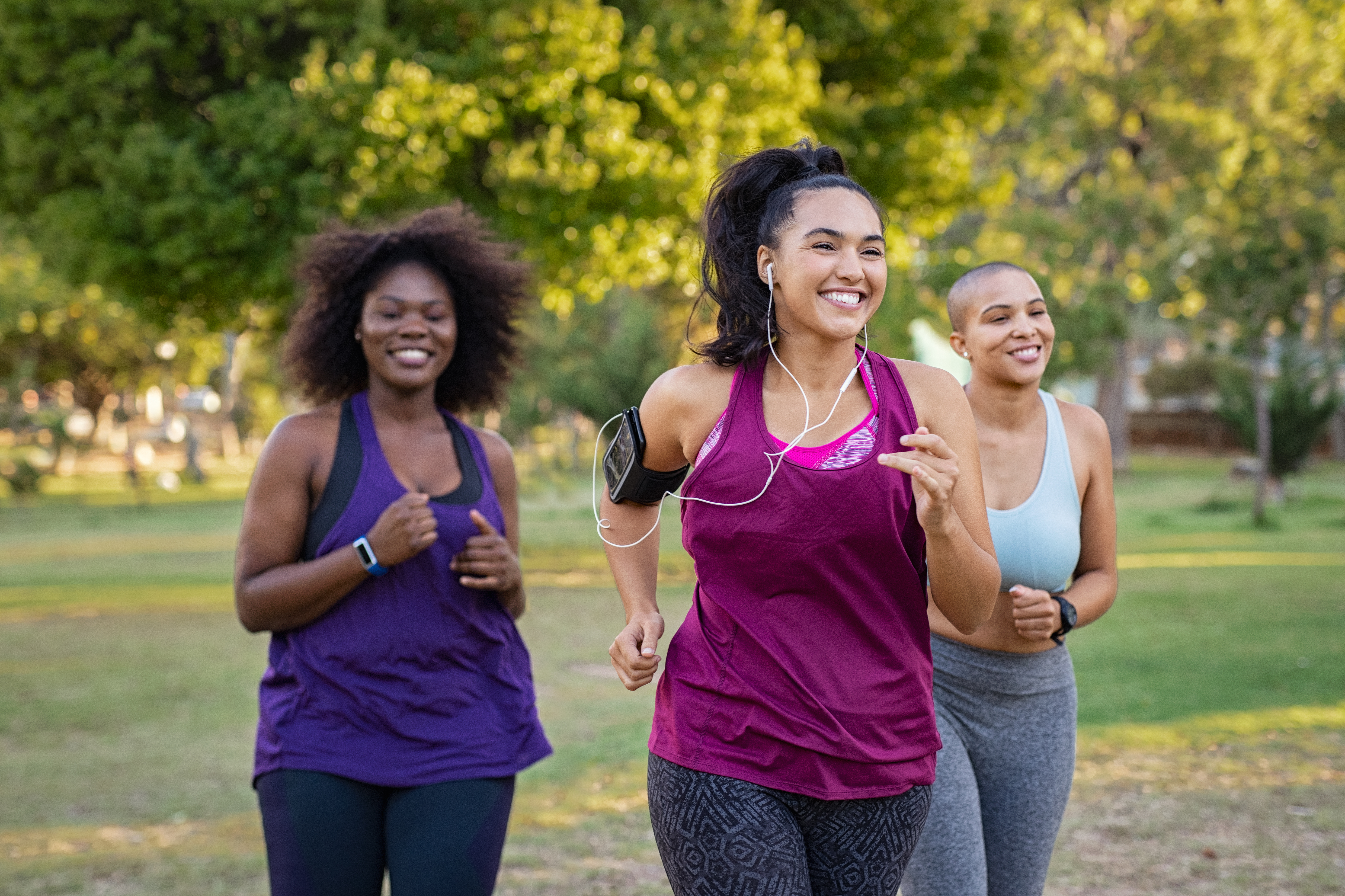 Three women running outside.