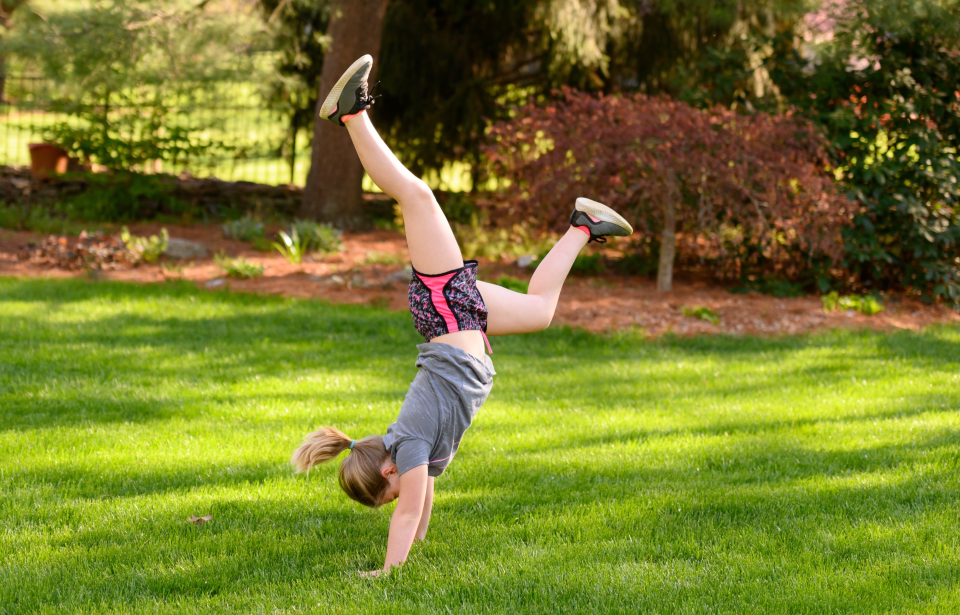 Sarah Beth does a handstand outside.