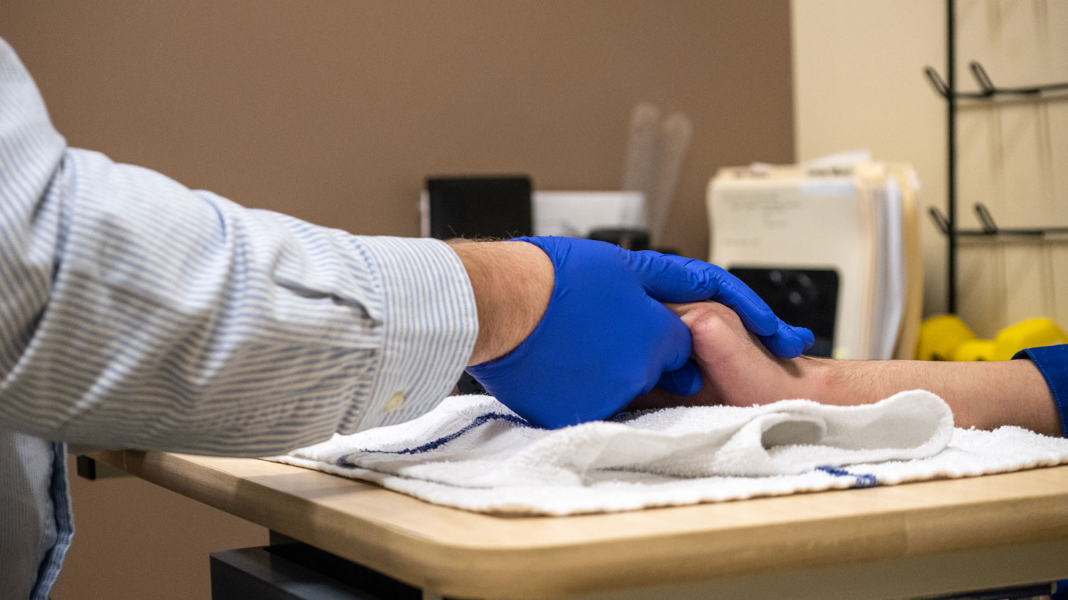 A hand therapist works with a young patient at the UK HealthCare Hand Center.