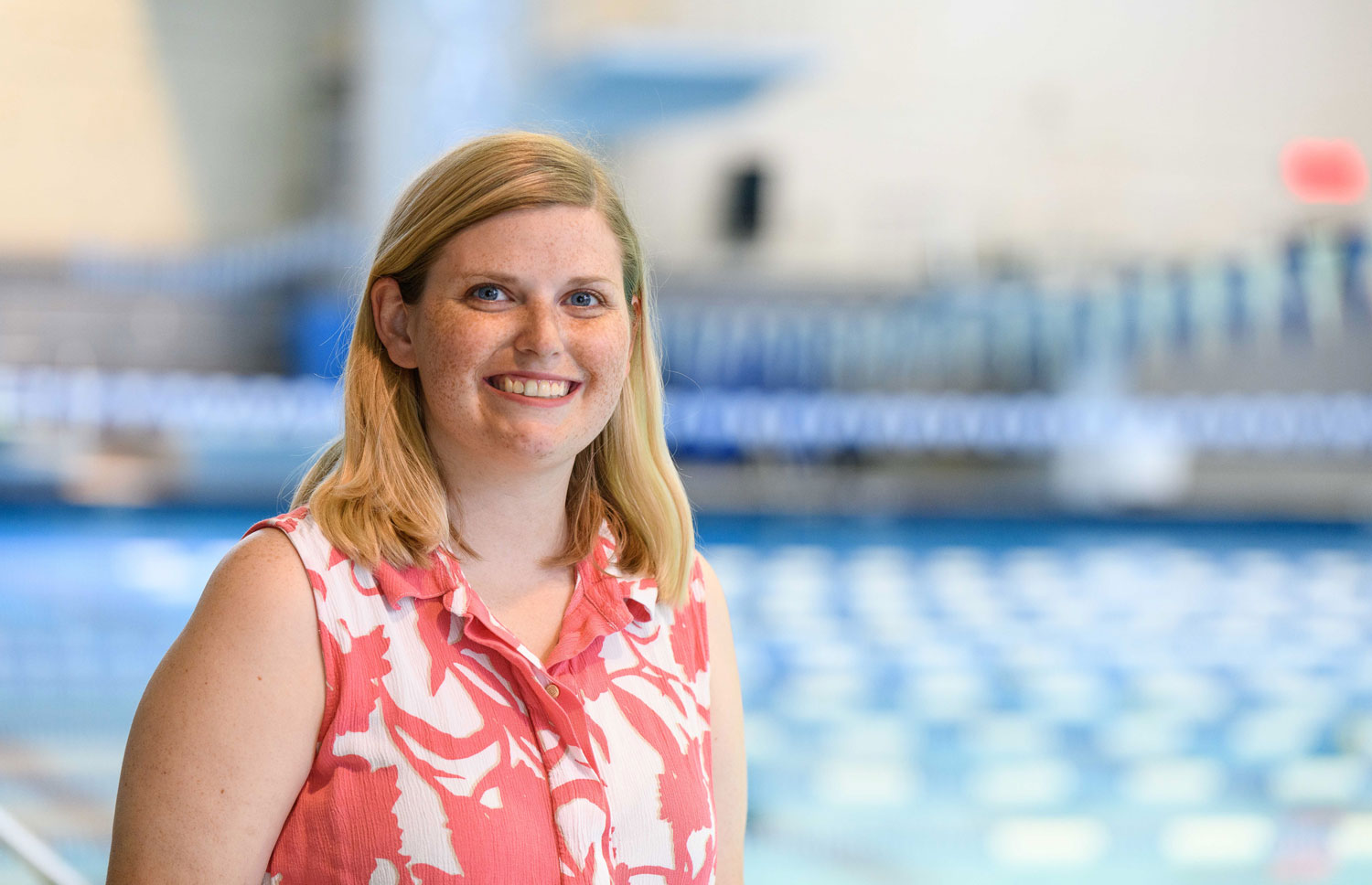 Alayna Benningfield stands by a pool.