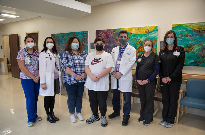 Tyson England, center, flanked on each side by three representatives from the Kentucky Children's Hospital Fatty Liver Clinic