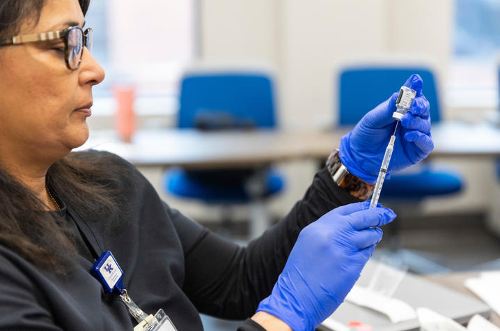 A pharmacist prepares medicine at UK Retail Pharmacy.