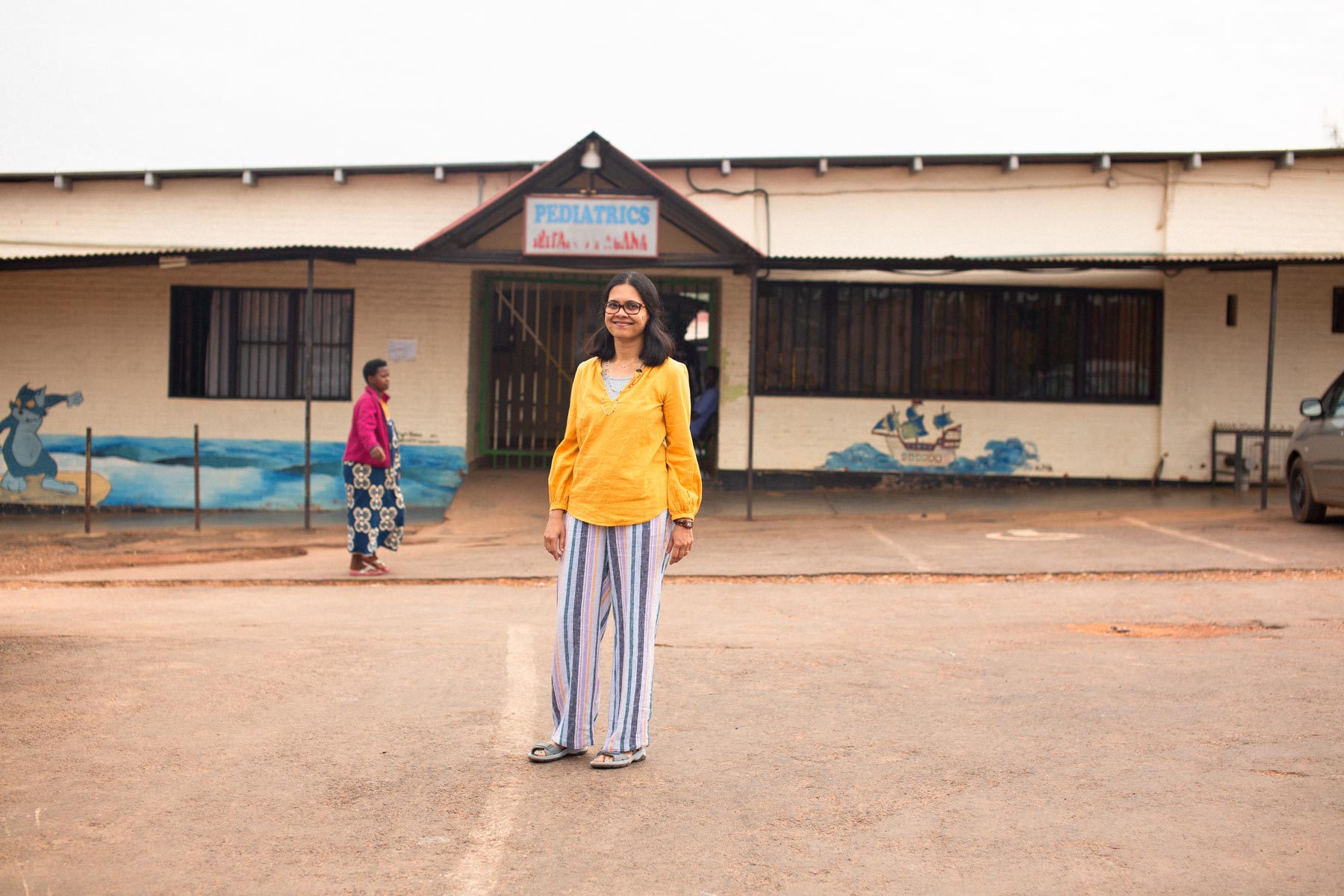 Dr. Shenoi in smiles front of an international pediatrics hospital.