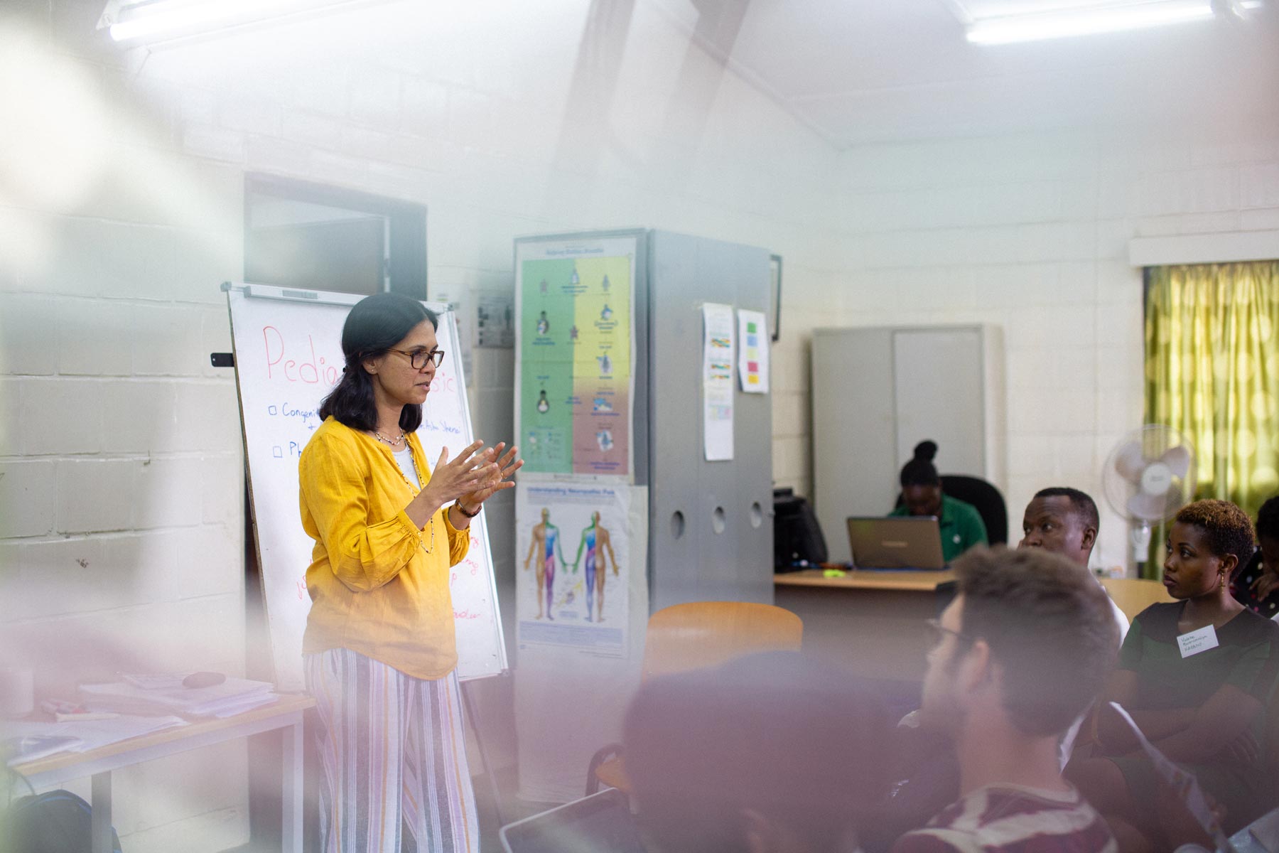 Dr. Shenoi teaches a group of doctors and nurses in Rwanda.