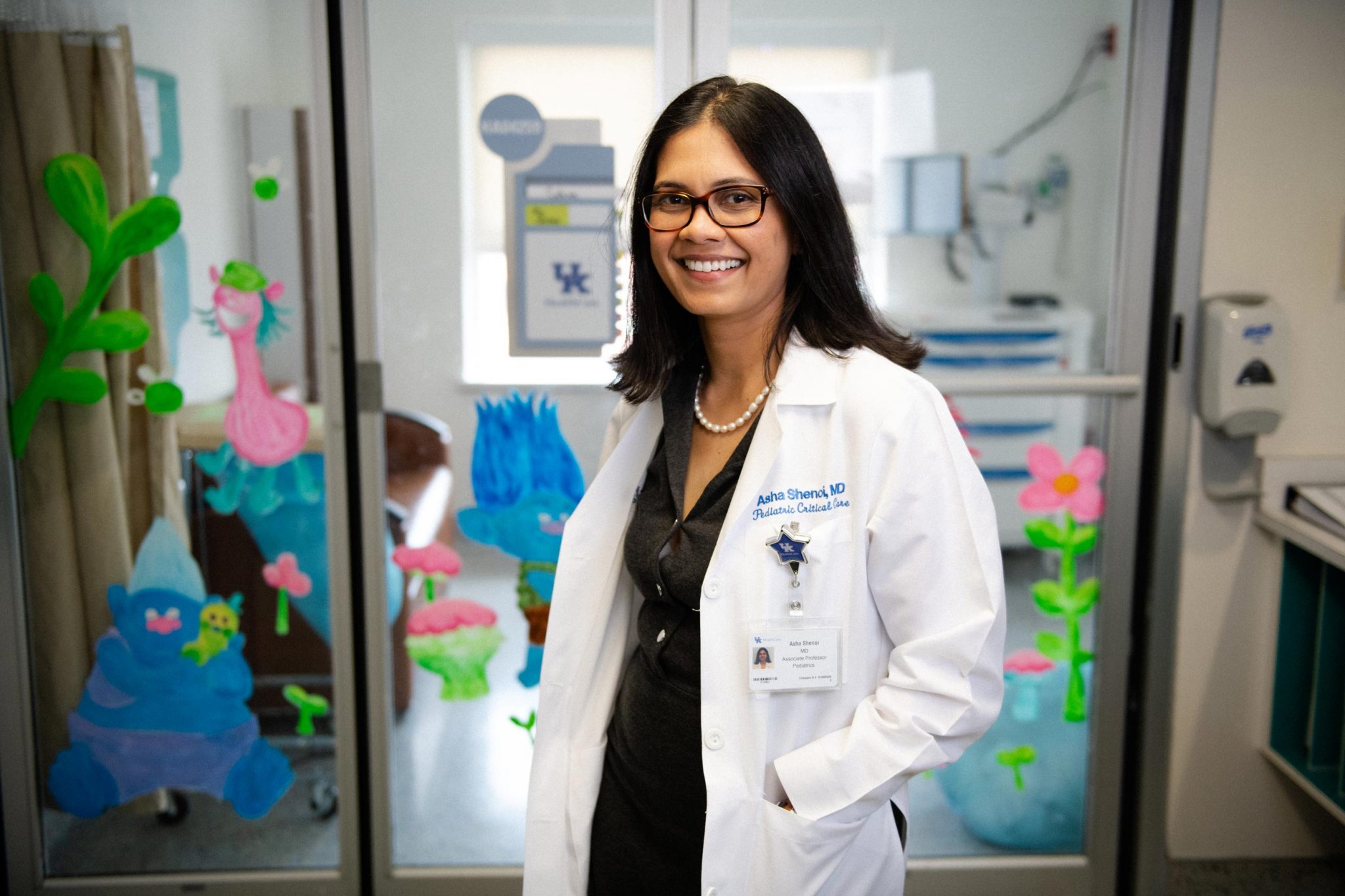Dr. Shenoi smiles while working in the pediatric ICU at UK HealthCare.