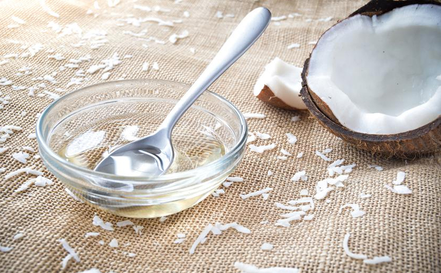 A bowl of coconut oil with a coconut.