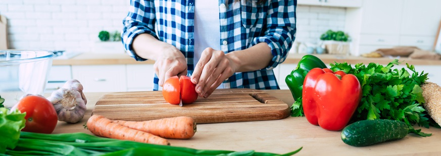 A person cuts a lemon in their kitchen.