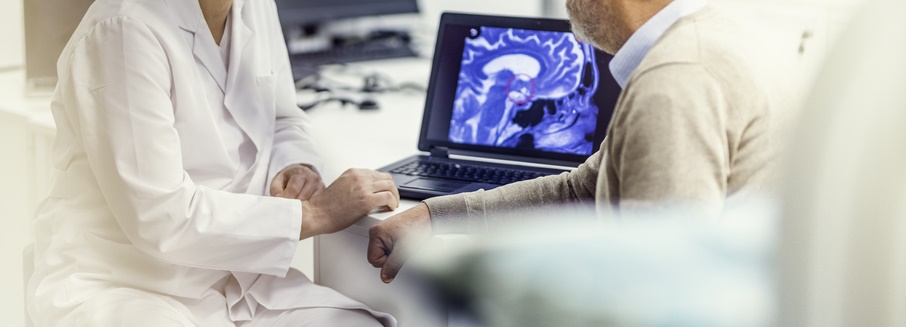 A doctor and their patient look at an MRI scan together.