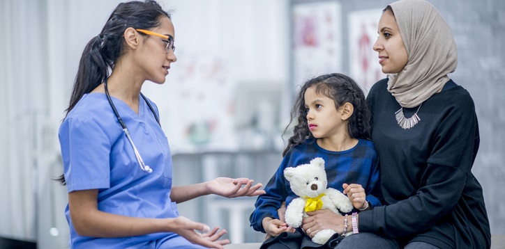 Doctor explains a procedure to a mom and her child.