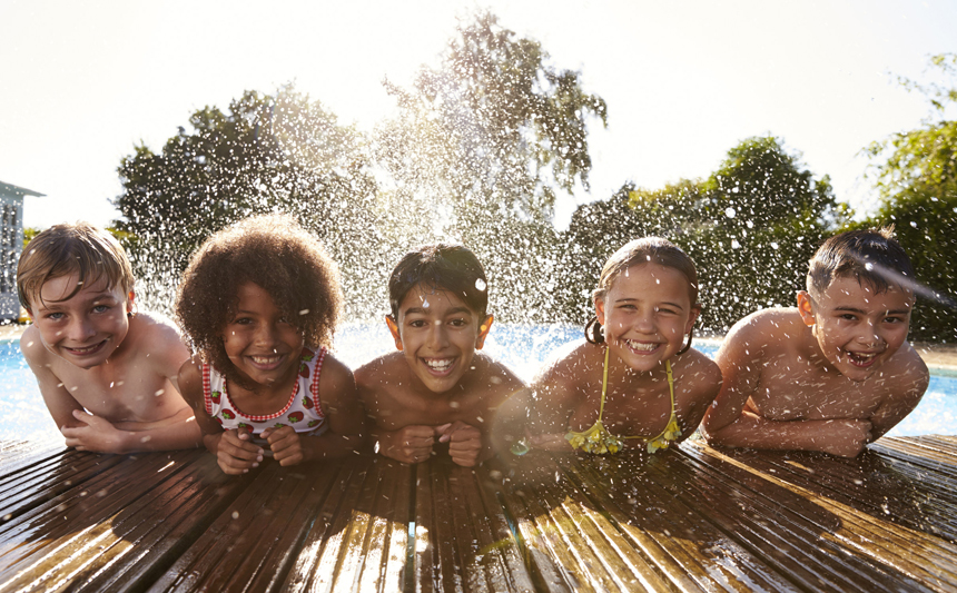 Five boys and girls at the pool's edge.