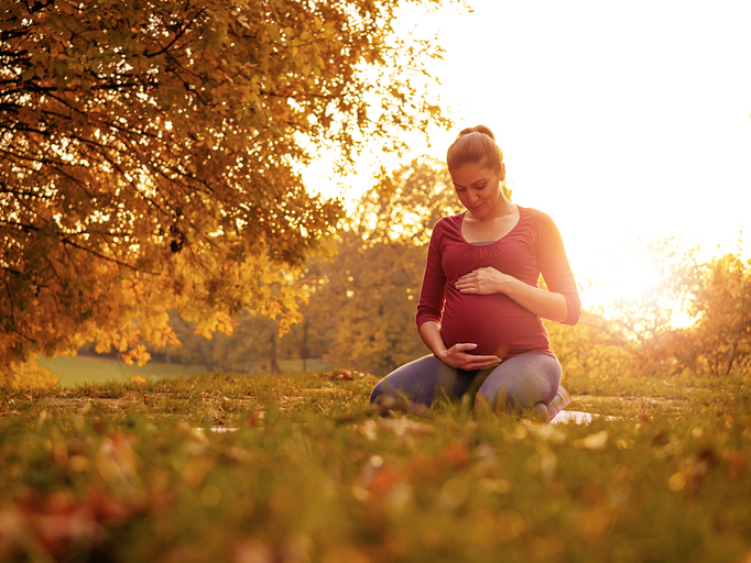 Pregnant woman holding stomach