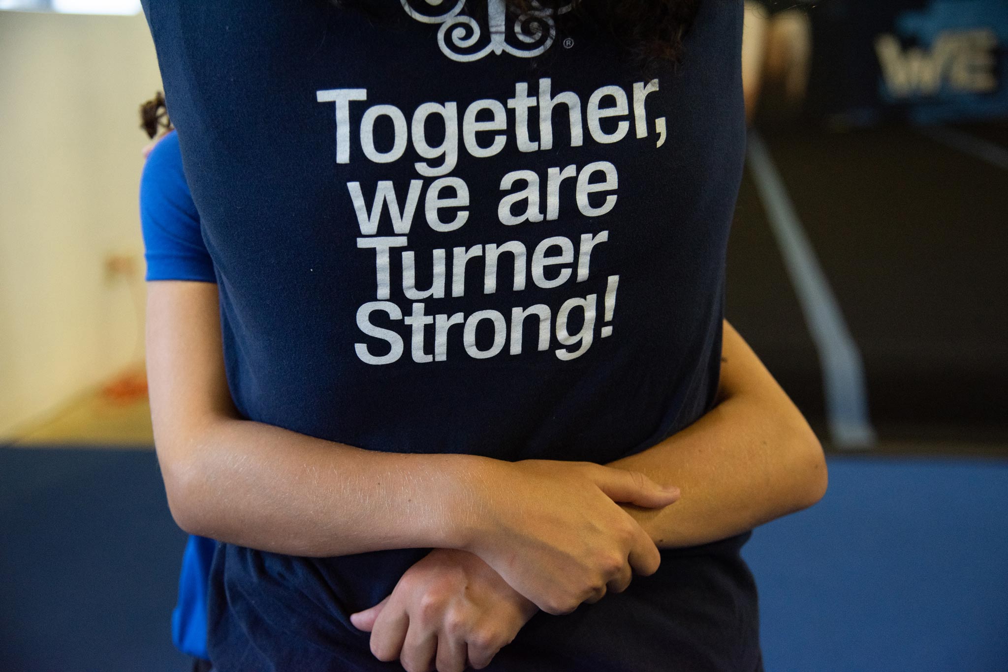 Photo features the back of a navy blue t-shirt that supports Turner Syndrome with the text “Together, We Are Turner Strong!”