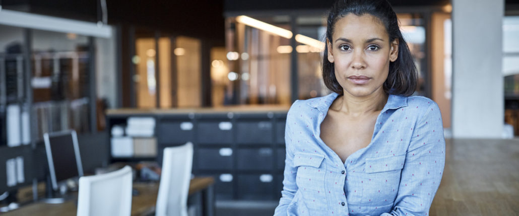 Woman standing in front of filing cabinets