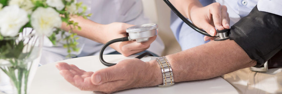 Nurse taking man's blood pressure.