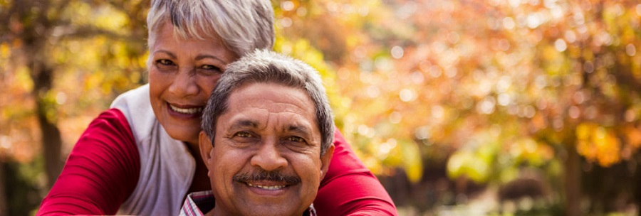 A man and woman smiling at the camera.