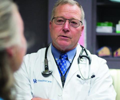 Thoracic surgeon Timothy Mullett, MD, talks with lung cancer patient Vickie Duff. Thoracic surgeon Timothy Mullett, MD, talks with lung cancer patient Vickie Duff.
