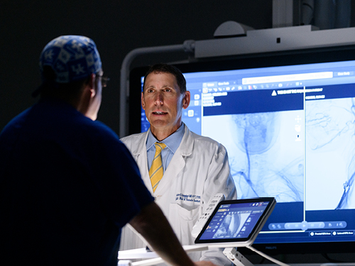 Dr. Aaron Hesselson talks with a colleague.