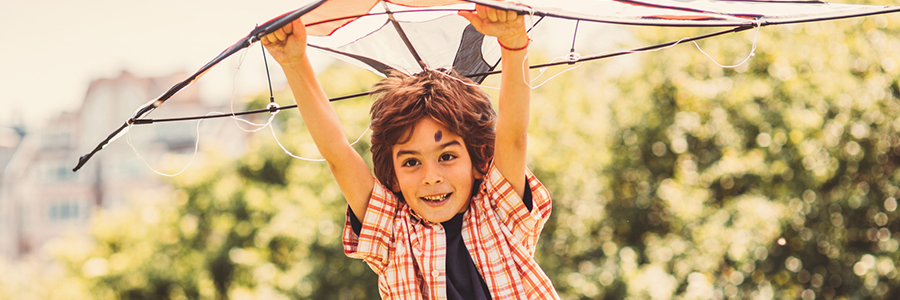 Little boy playing with a kite in the park.