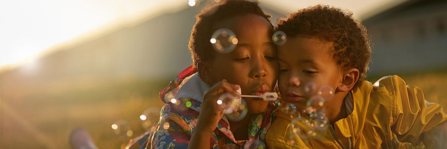 Two boys blowing bubbles