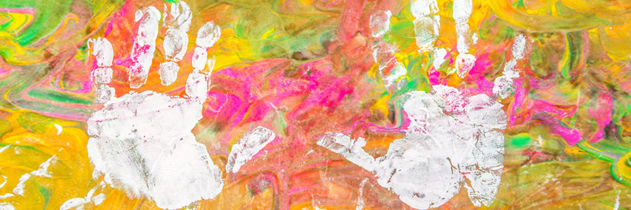 A child's handprints in colorful paint.