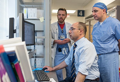 Doctors looking at a computer screen