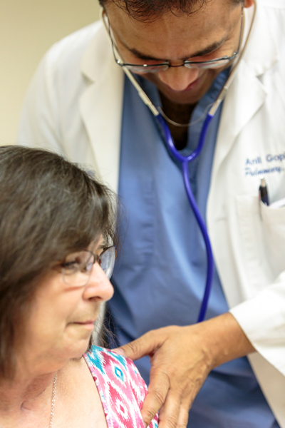 Dr. Anil Gopinath listens to Glenda Brown's lungs.