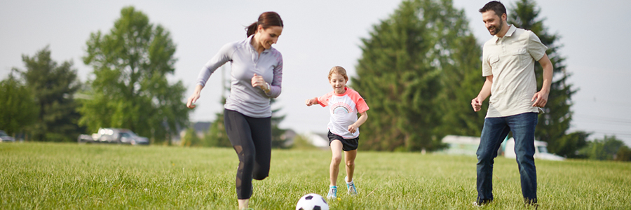 Family playing soccer