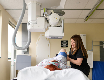 A provider examines a patient's knee.