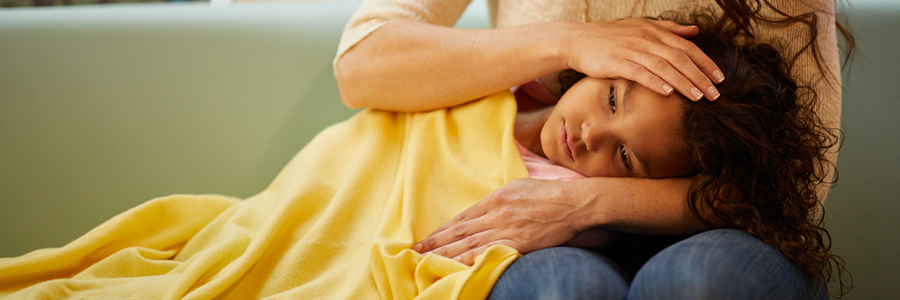 Sick child laying in mother's lap