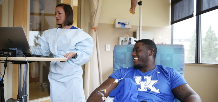 Markey nurse Leila Scandrani gets Paschal set up with his immunotherapy infusion.