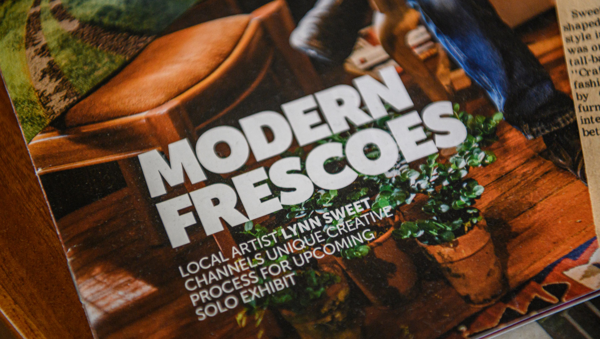 A close-up of a magazine cover with the headline MODERN FRESCOES: Local artist Lynn Sweet channels unique creative process for upcoming solo exhibit.