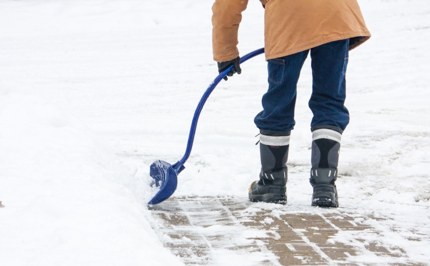 A man shovels snow.