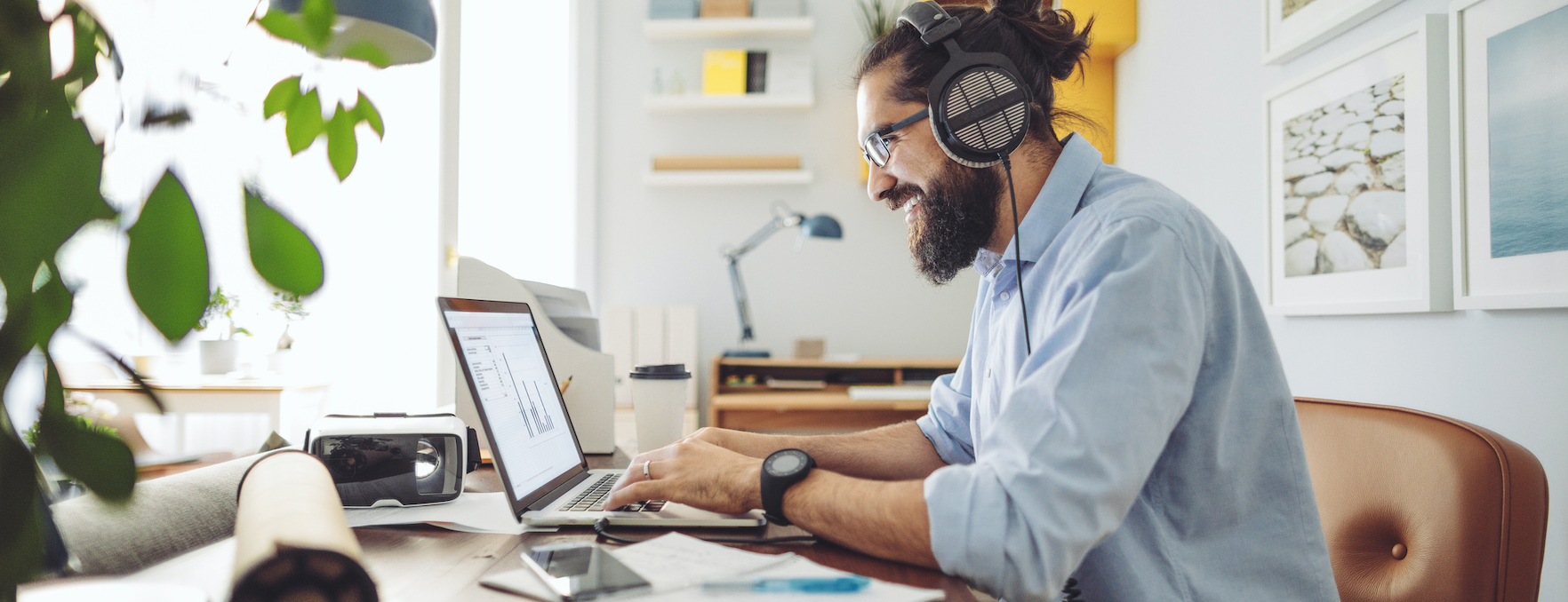 Man sitting at desk working on computer. 