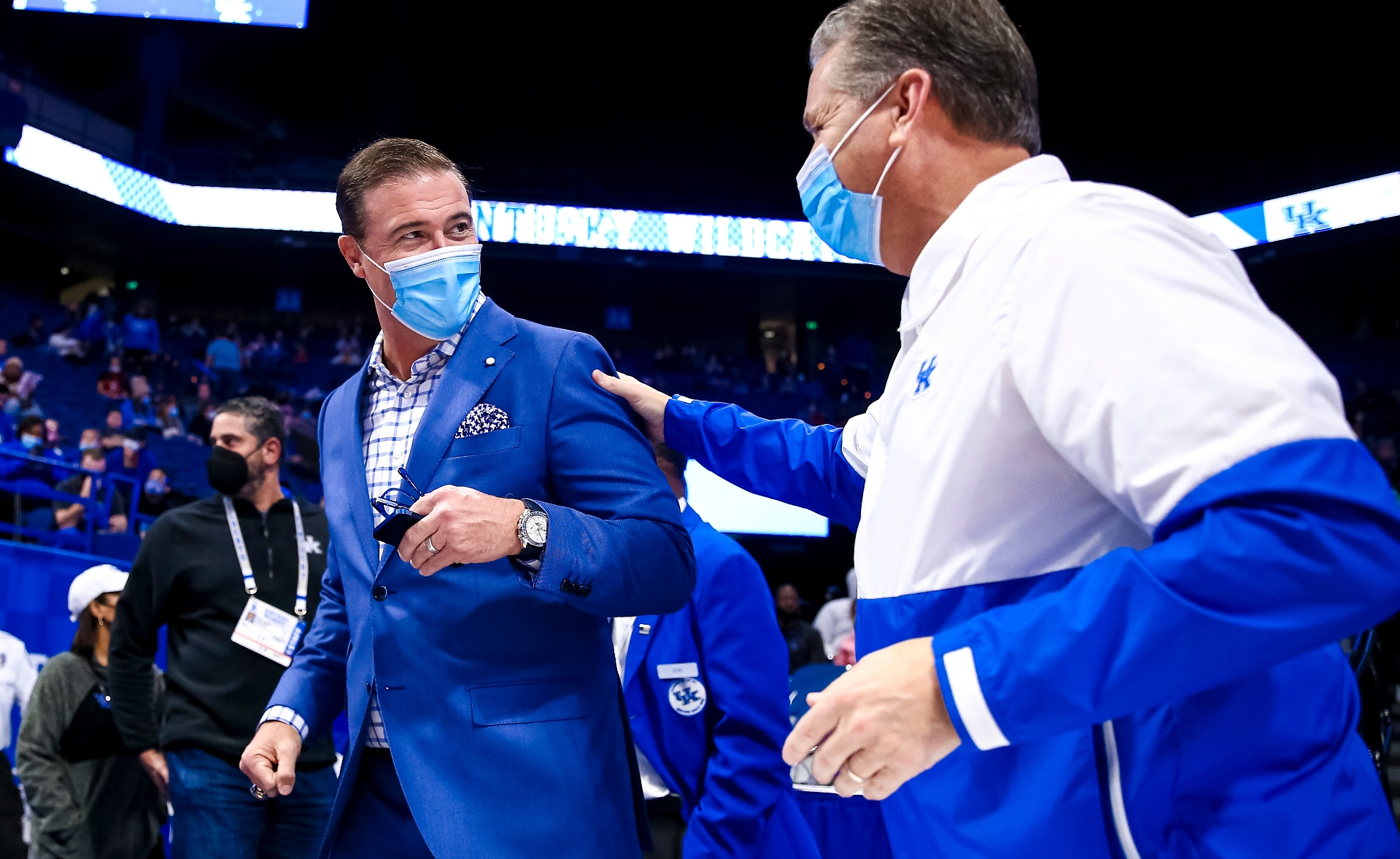 A candid photo of Coach Mitchell being congratulated after a game.