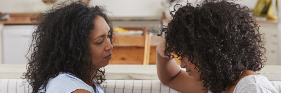 A mother talks with her unhappy teenaged daughter.