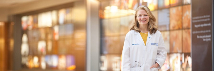 Dr. Rachel Miller stands in front of the Kentucky Wall at UK Albert B. Chandler Hospital.