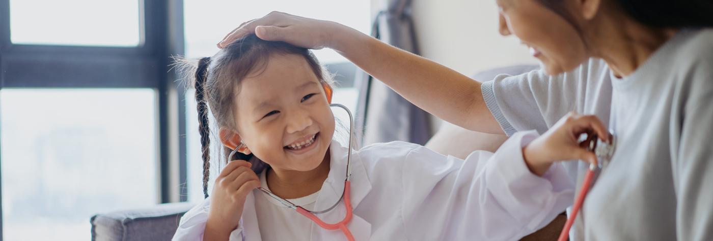 A little girl uses a stethoscope to listen to her mother's heartbeat.