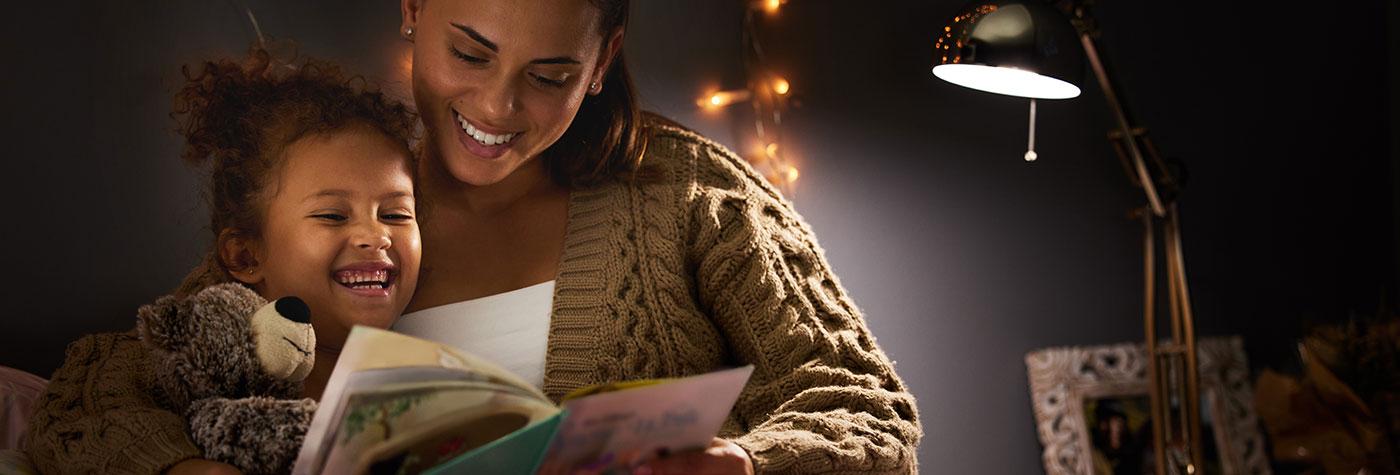  young mother reading her daughter a bedtime story