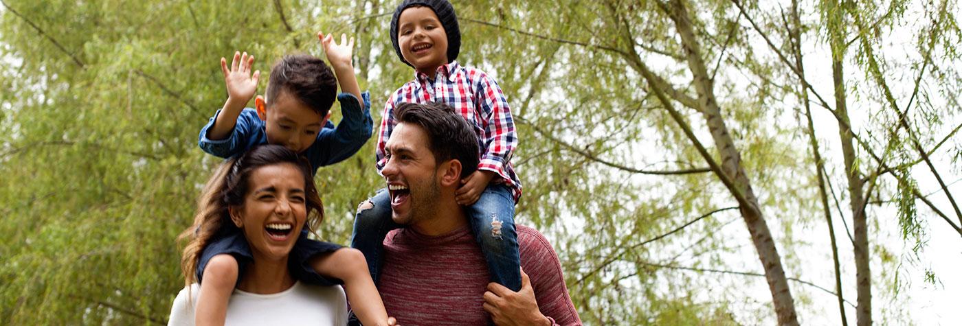 Family formed by parents and children of latin ethnicity of different ages have fun playing in the field