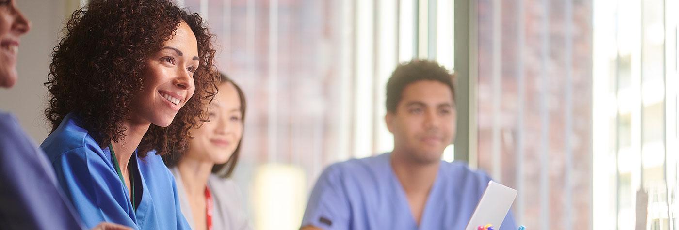 A group of providers meet in a conference room. 