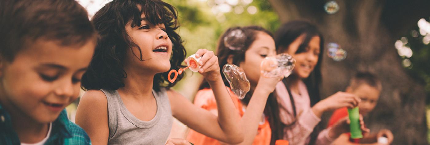 Children blowing bubbles.