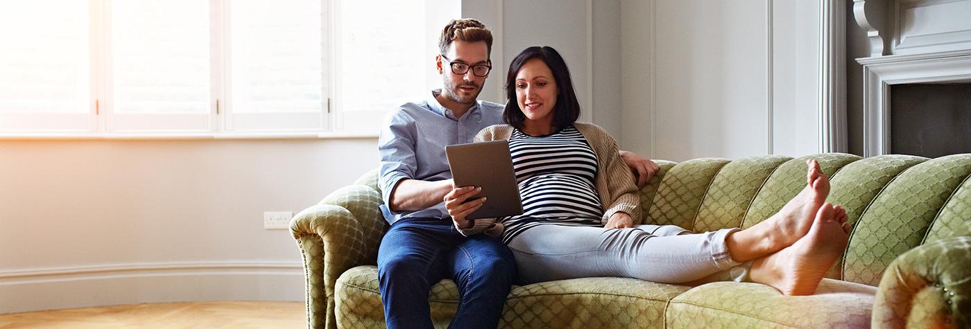 couple on couch with tablet