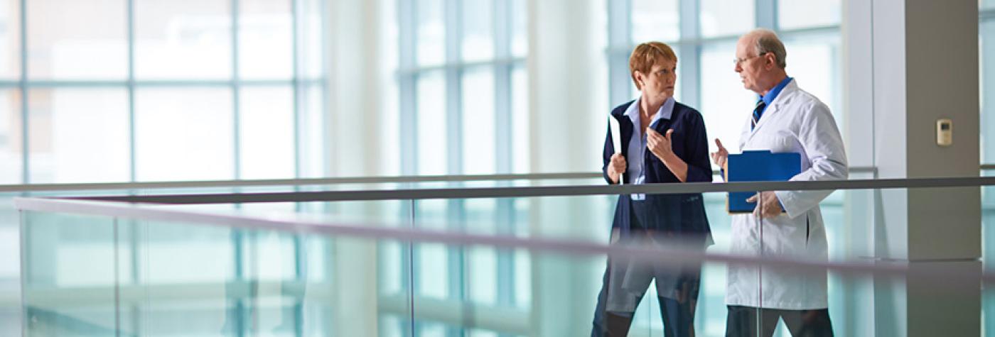 two researchers walking and talking to one another