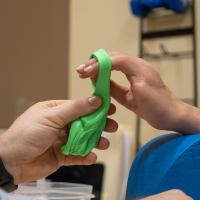 Rehab therapist Matthew Rose, left, works with Levi Yoder.