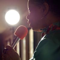 Debra Faulk, a stand-up comedienne, performing a routine.