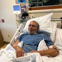 Raymond Cloud in a hospital bed following his lung transplant in March 2022.