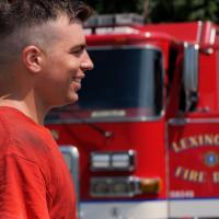 Nick Corman walking in front of a firetruck