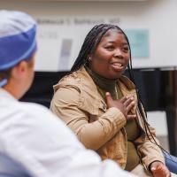 Tiona Stevenson, while seated in a circle of family and friends, speaks graciously about the care she's received from Dr. David Dornbos, who's seated near her.